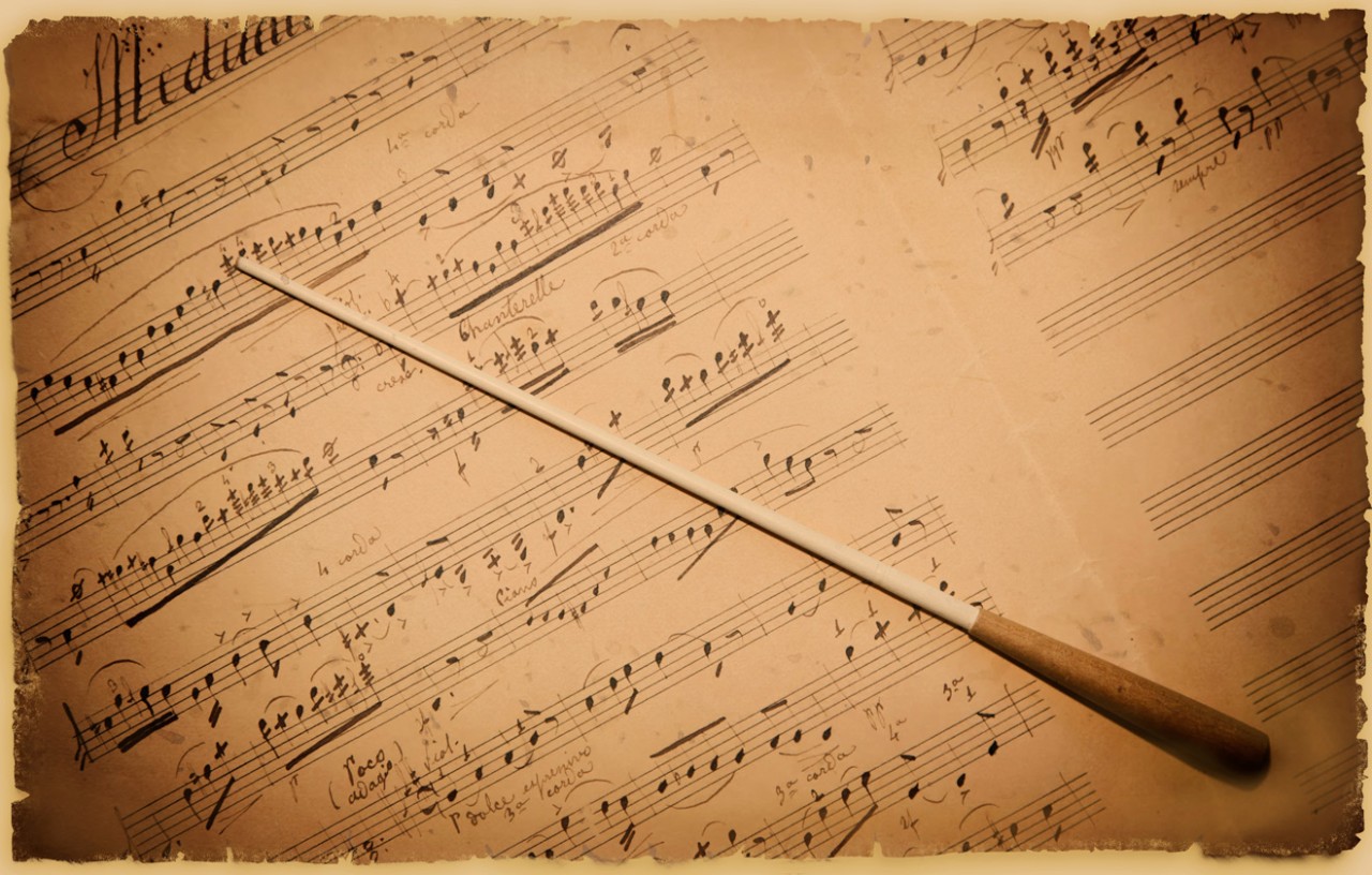 A vintage brown sheet music with a composer baton on top